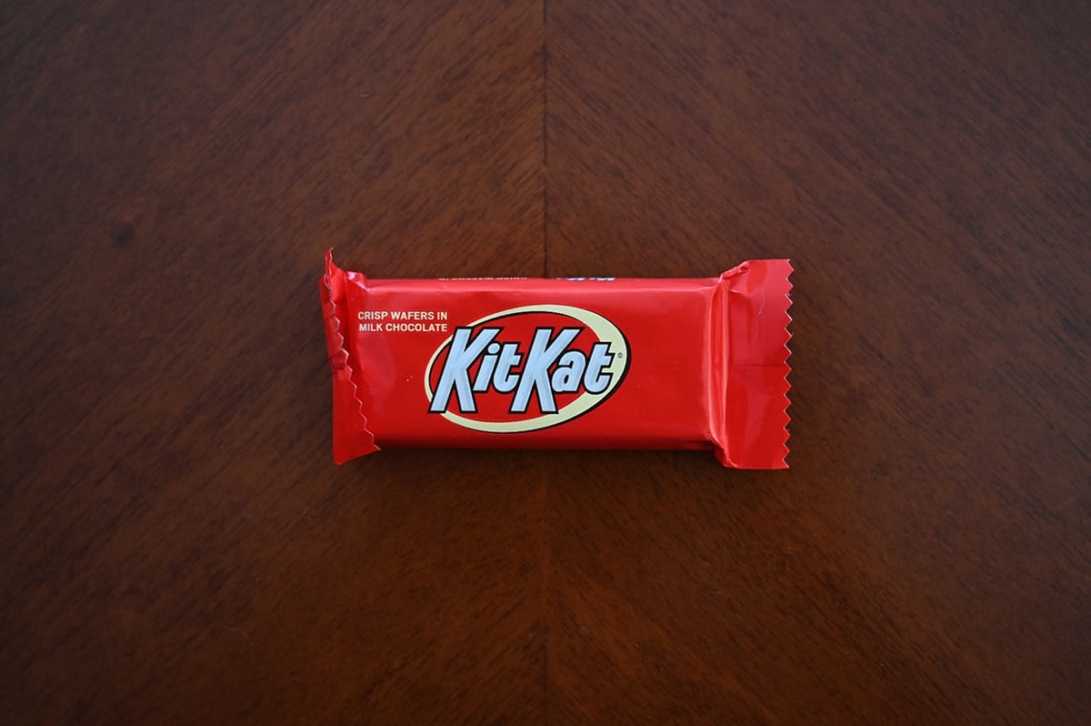 Top down image of an unopened Kit Kat chocolate bar sitting on a table.
