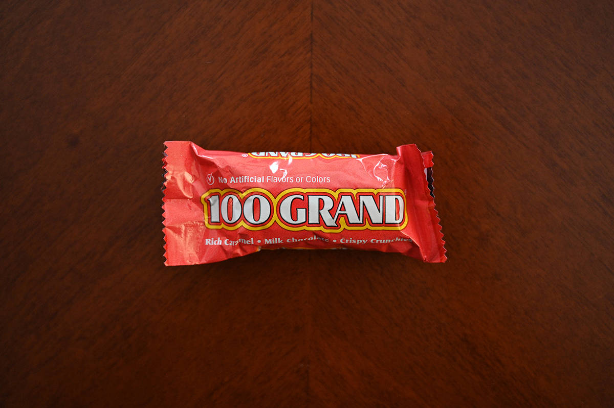 Top down image of a 100 Grand chocolate bar sitting on a table unopened.