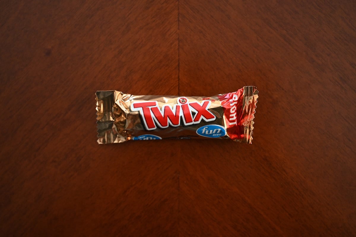 Top down image of an unopened Twix Chocolate Bar sitting on a table.