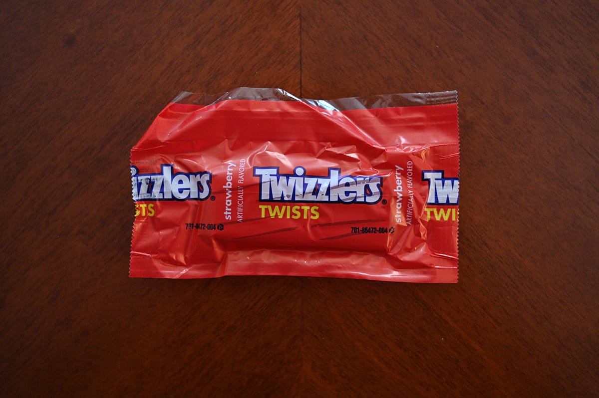 Top down image of Twizzlers Twists candy sitting on a table unopened.