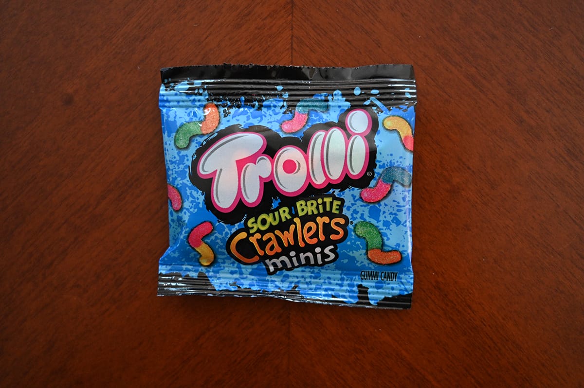 Top down image of Trolli Sour Brite Crawlers Minis candy sitting on a table unopened.
