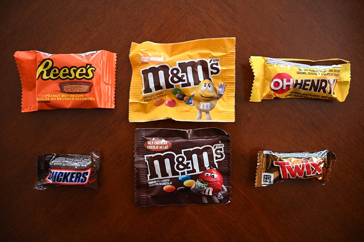 Top down image of all the kinds of chocolate bars that come in the Favourites bag, on a table unopened.
