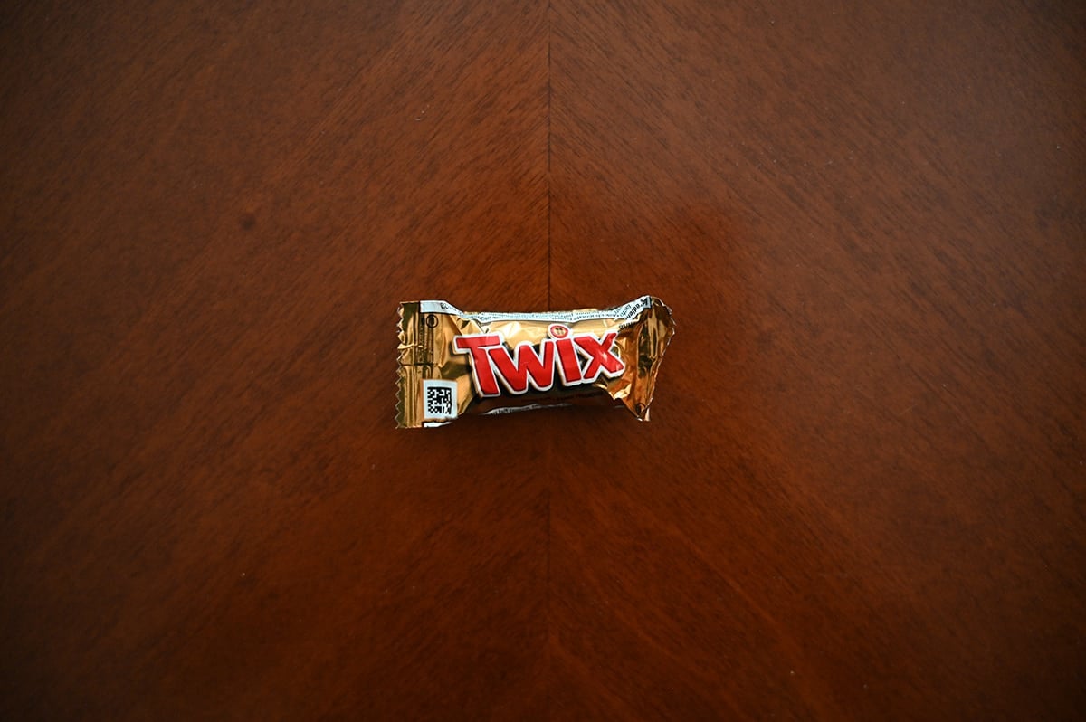 Top down image of an unopened Twix bar sitting on a table.