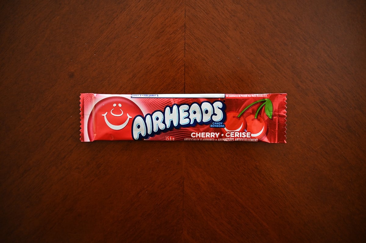 Top down image of an Airheads candy sitting on a table unopened.