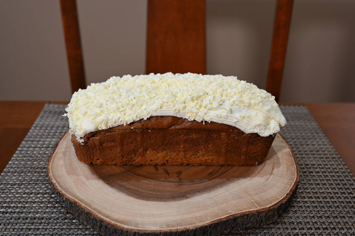 Side view image of the pumpkin spice loaf out of the packaging and served on a cutting board. 