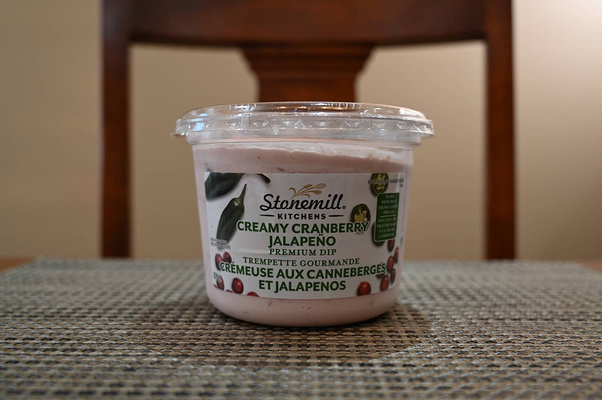 Image of the Costco Stonemill Kitchens Creamy Cranberry Jalapeno Dip container sitting on a table.