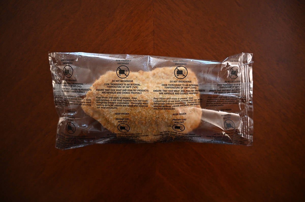 Image of one individually packaged chicken breast unopened sitting on a table.