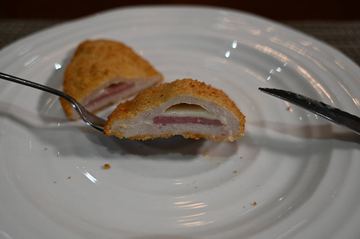 Side view image of one cooked chicken breast cut in half so you can see what the center looks like.