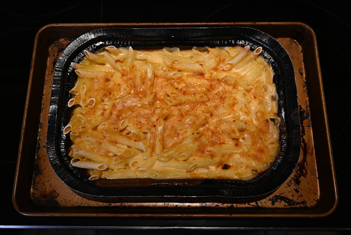 Top down image of the tray of mac and cheese sitting on the stove top, it has been fully baked at this point.