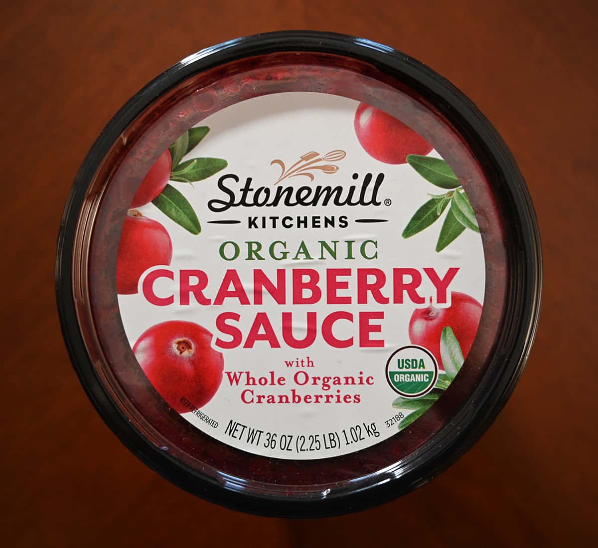 Top down image of the Costco Stonemill Kitchen Organic Cranberry Sauce container top showing that it's organic and weighs 1.02 kiligrams. 