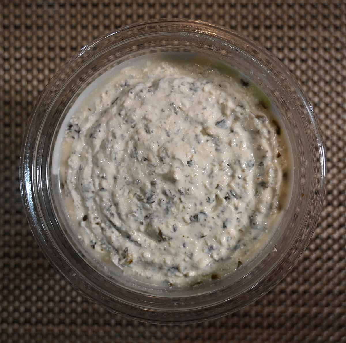 Top down image of an open container of dip showing what it looks like.
