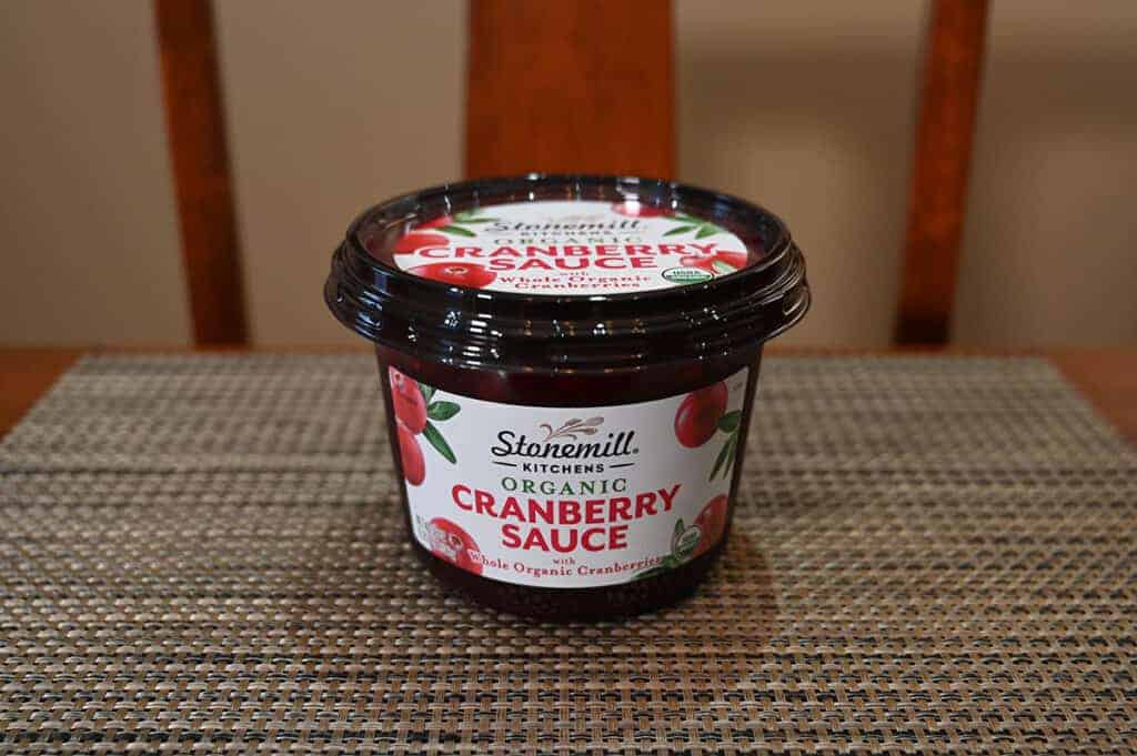 Image of the Costco Stonemill Kitchens Organic Cranberry Sauce container unopened sitting on a table.