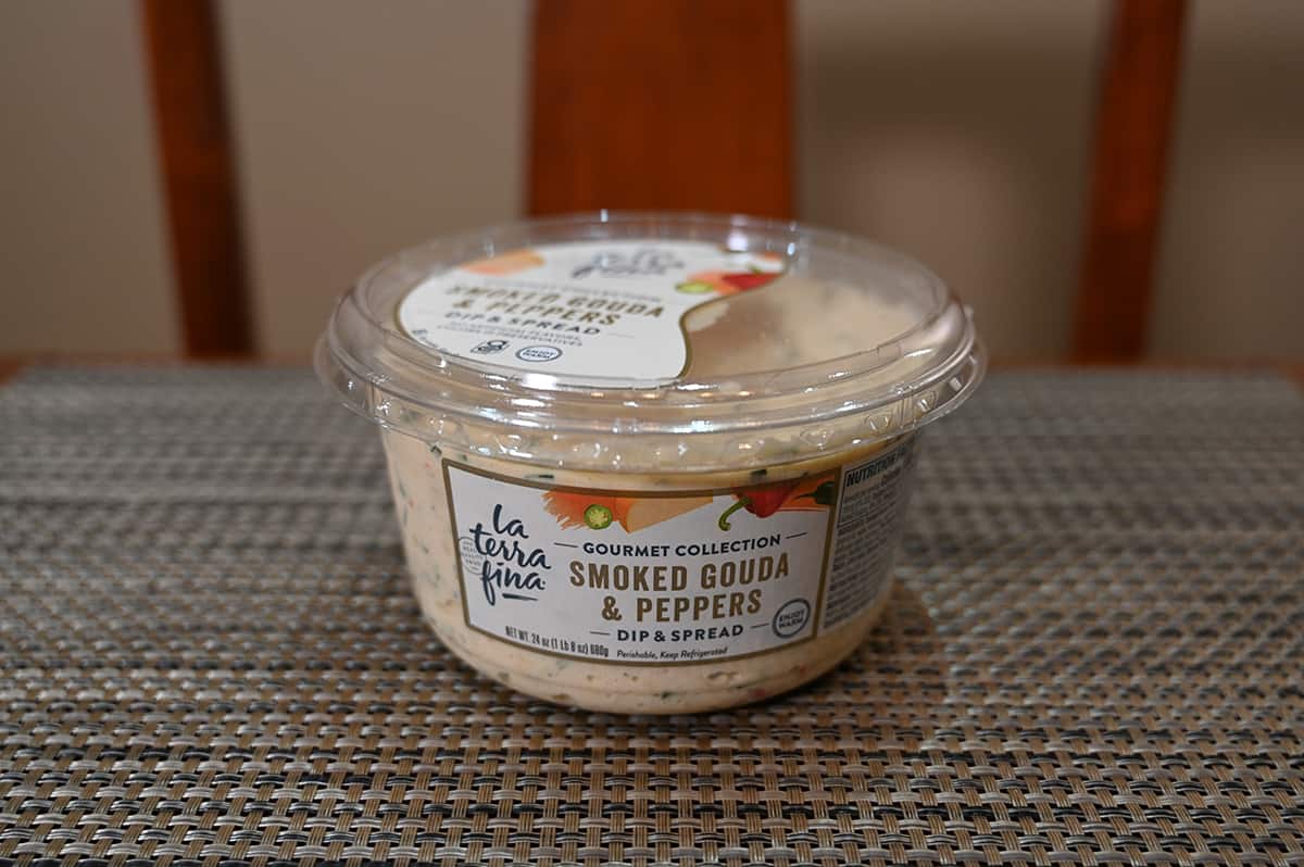 Image of an unopened Costco La Terra Fina Smoked Gouda & Peppers Dip container sitting on a table.
