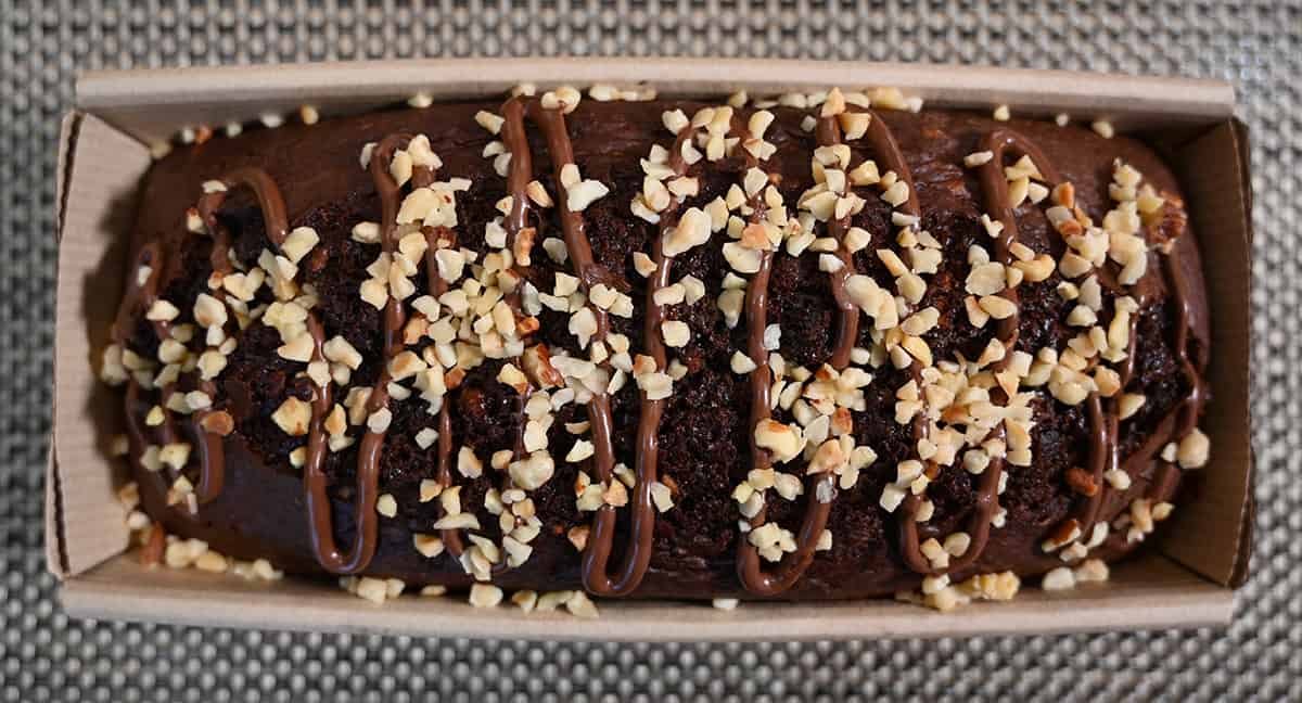 Top down image of the Costco Kirkland Signature Hazelnut Loaf opened so you can see the top of the loaf with hazelnuts and a drizzle.