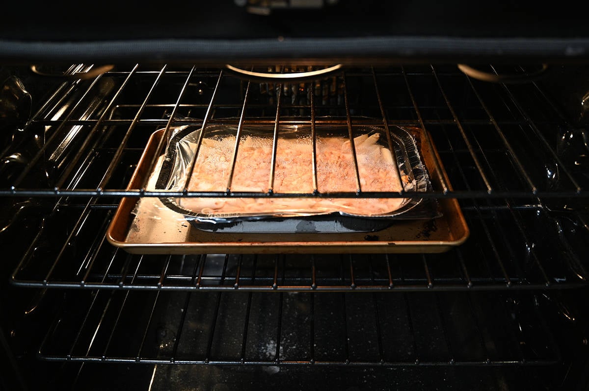 Sideview image showing an open oven with the tray of mac and cheese baking in the oven.