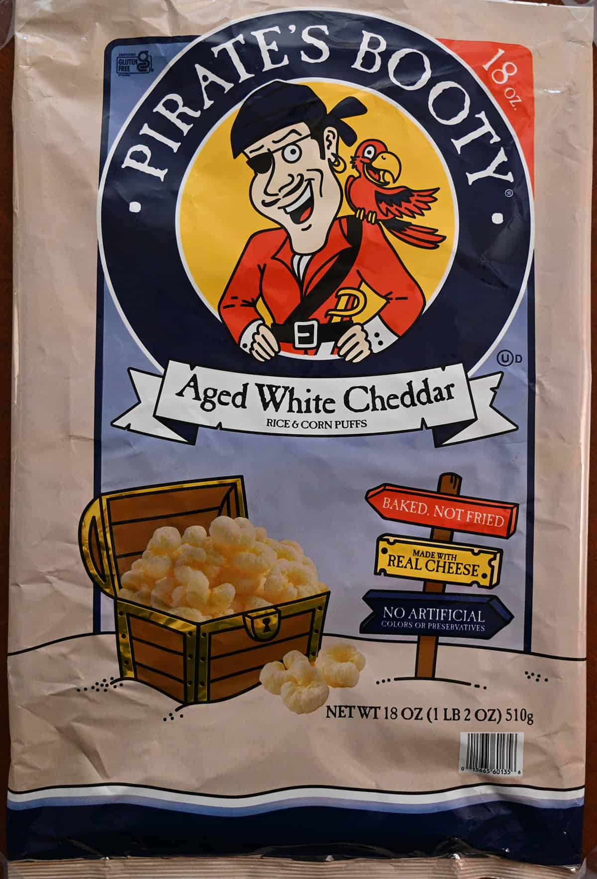 Closeup image of the front of the bag showing that Pirate's Booty has no artificial colors or preservatives and are baked, not fried.