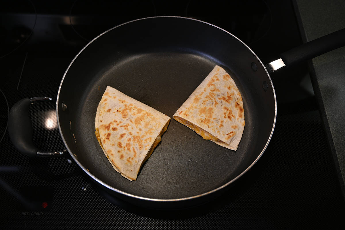 Top down image of two quesadillas after being cooked in the pan.