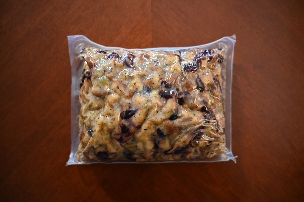 Top down image of a vacuum-sealed pouch of stuffing unopened sitting on a table.