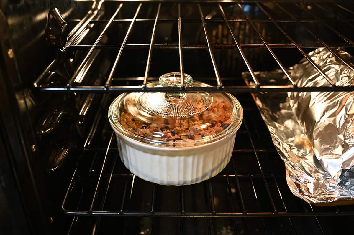 Image of a casserole dish of stuffing baking in the oven on the middle rack.