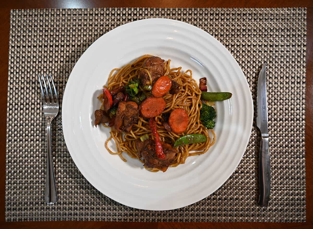 Top down image of a white plate with chicken yakisoba served on it.