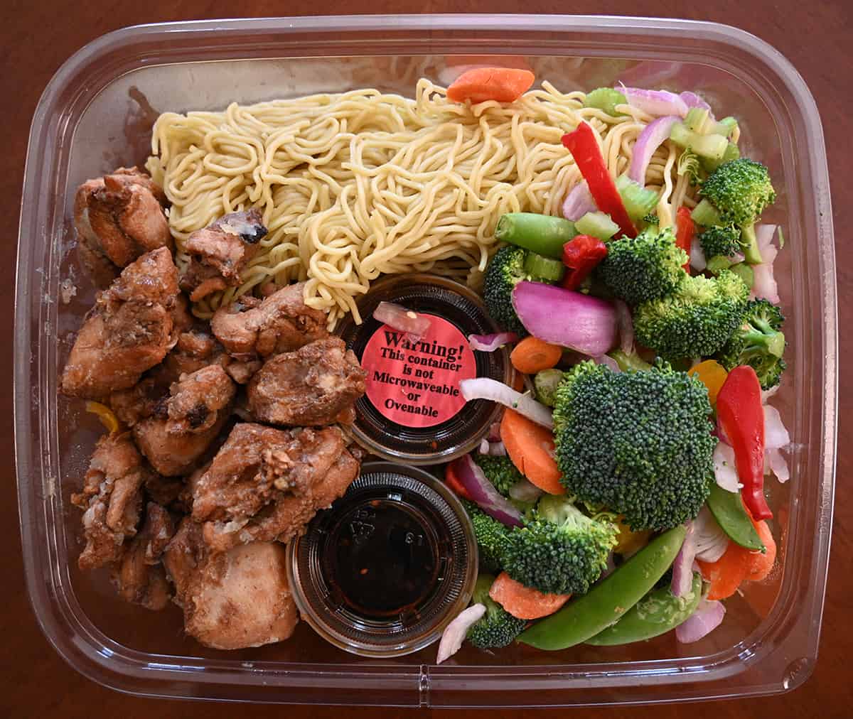 Top down image of the Costco Kirkland Signature Yakisoba Stir Fry sitting on a  table opened so you can see all the ingredients.
