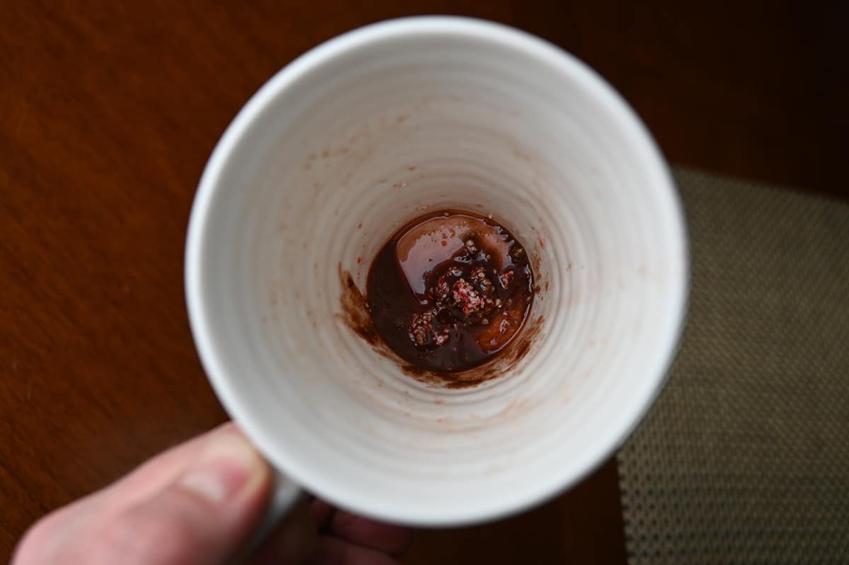 Top down image of a mug with candycane cocoa residue in the bottom of it.