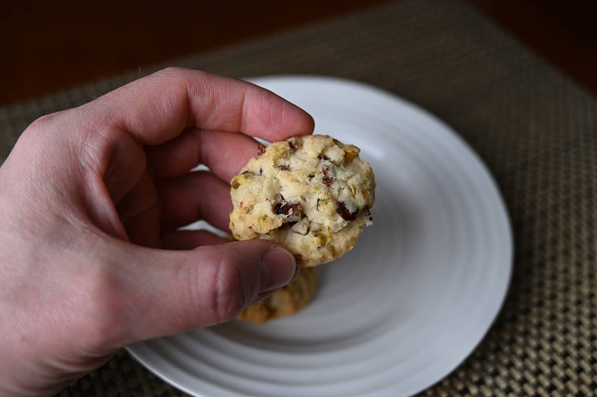 Image of a hand holding one cookie close to the camera so you can see what it looks like.
