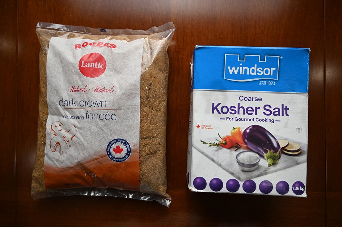 Image of the ingredients for the turkey brine sitting on a table, brown sugar and salt.