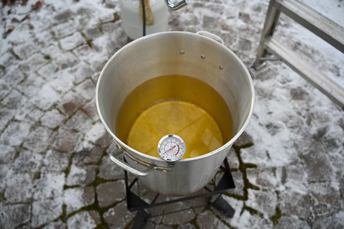 Top down image of a full pot of hot peanut oil in a large pot.