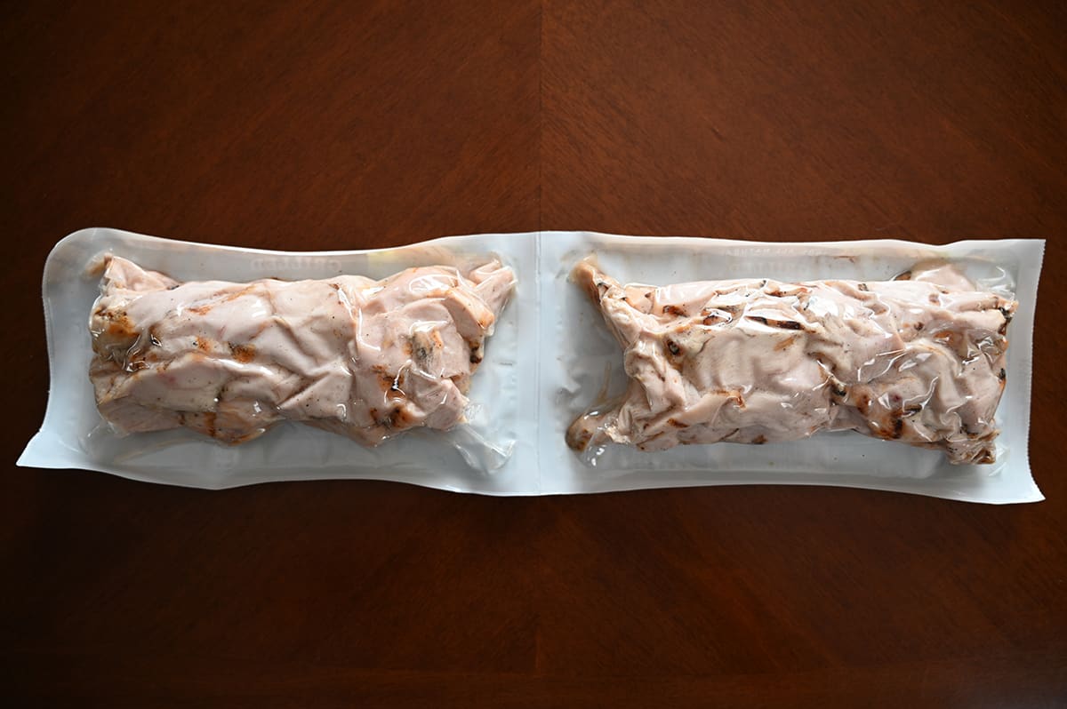 Top down image of the back of the two-pack of chicken strips showing the chicken in the package through the clear plastic.