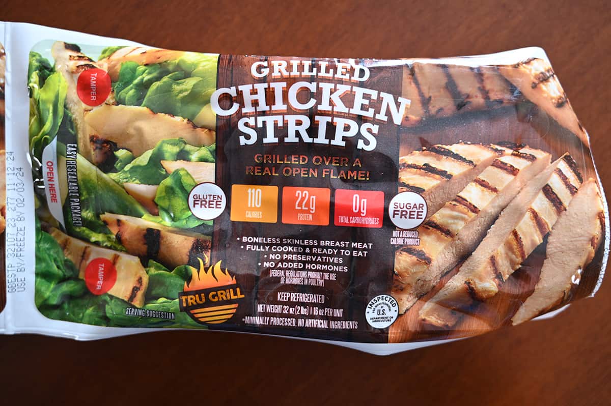 Top down closeup image of one pack of chicken strips showing the weight of the chicken and where it is made.
