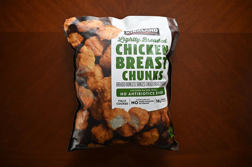 Image of the Costco Kirkland Signature Lightly Breaded Chicken Breast Chunks bag sitting on a table unopened.
