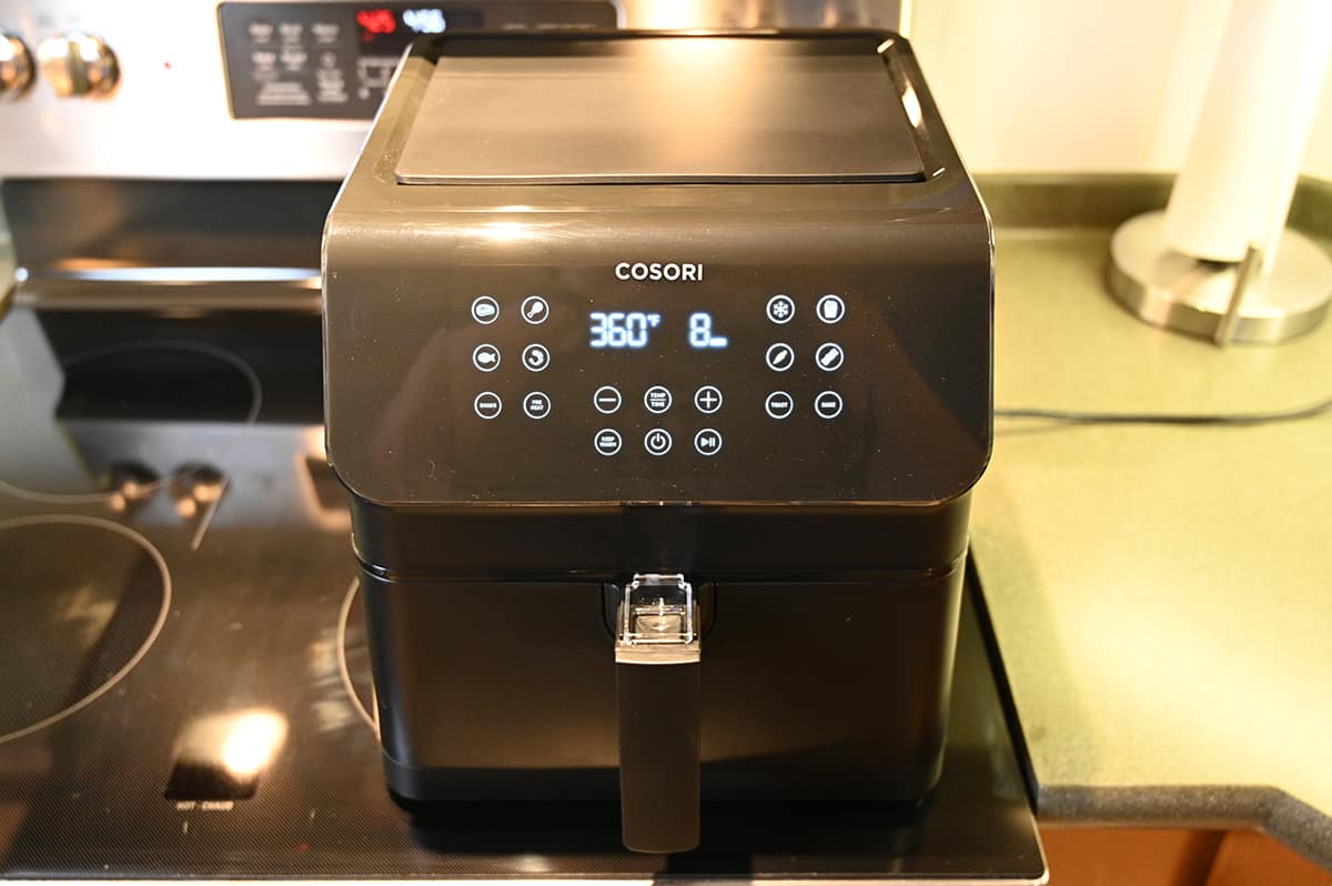 Image of an air fryer sitting on top of a stovetop.