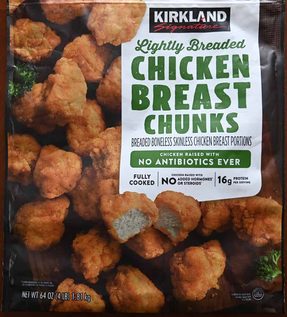 Closeup image of the front of the chicken breast chunks bag showing fully-cooked, chicken raised without hormones or steroids.
