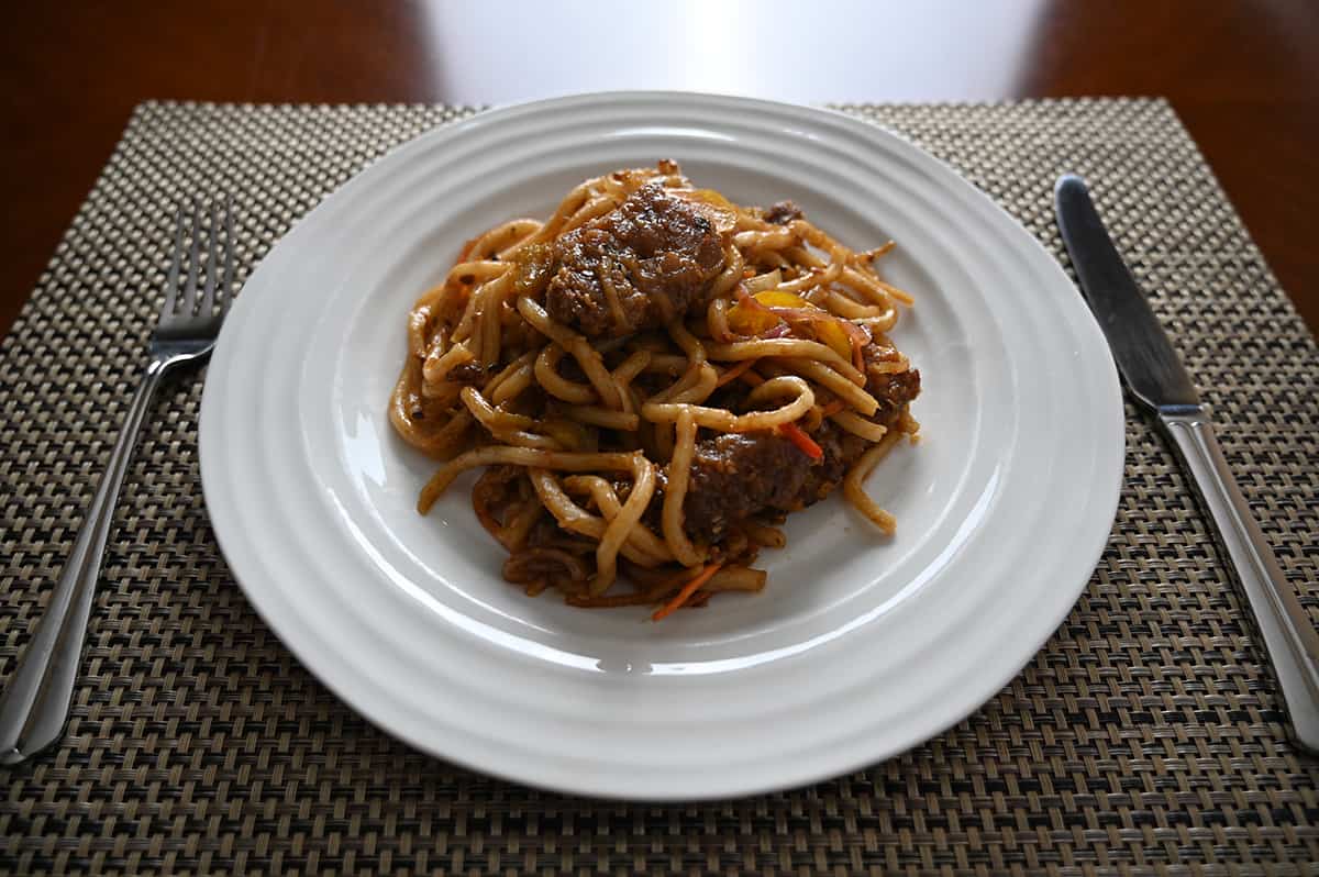 Sideview top down image of a plate of noodles and gingetbeef served.