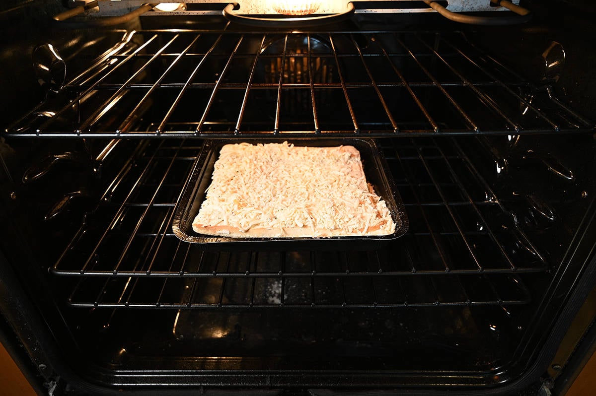 Image of the cheese bread cooking in the oven on the middle rack.
