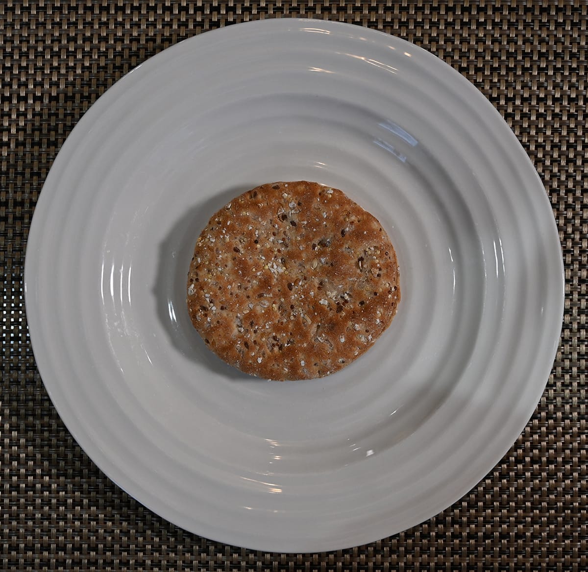 Top down image of one sandwich thin served on a white plate.