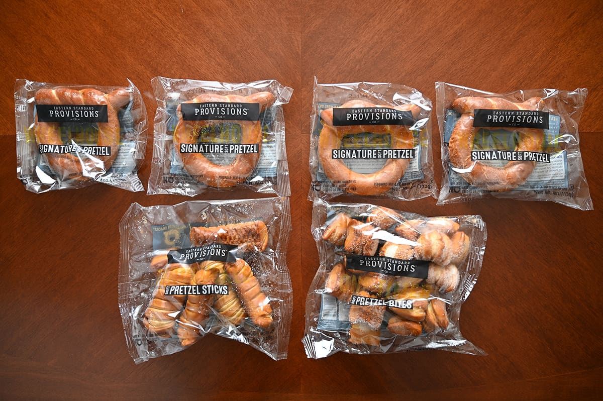 Top down image of all the pretzels that come in the box in their plastic packaging unopened sitting on a table.