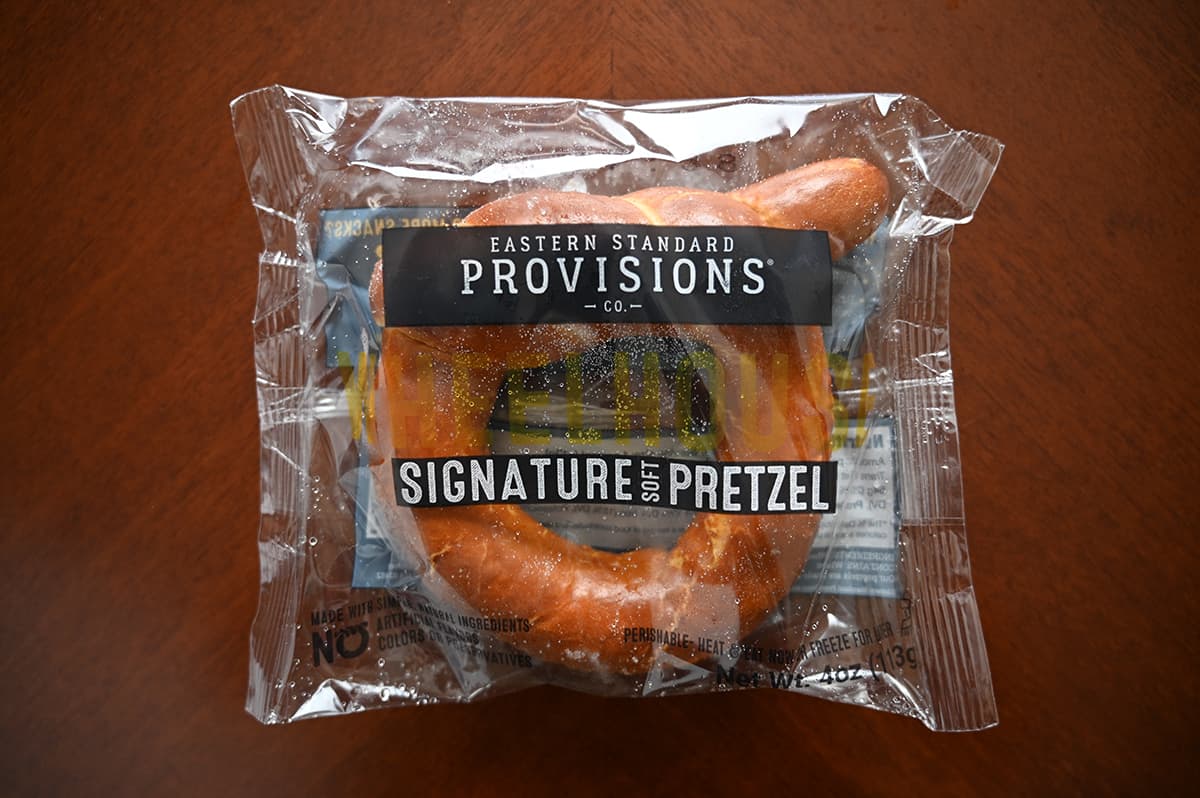 Top dow image of one wheelhouse pretzel unopened in plastic packaging sitting on a table.