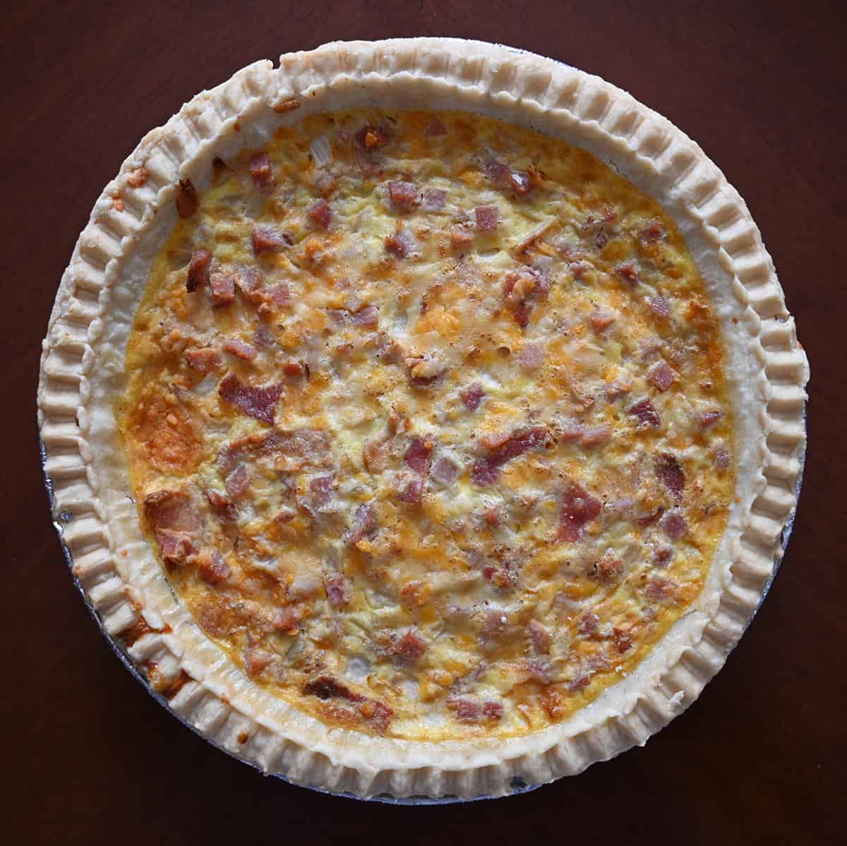 Top down image of the Costco Kirkland Signature Quiche with the lid off prior to baking it.