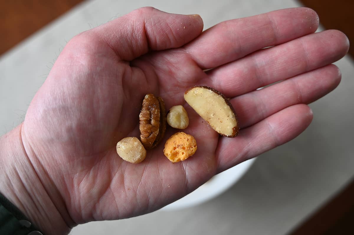 Closeup image of the keto snack mix in an open palm of a hand.