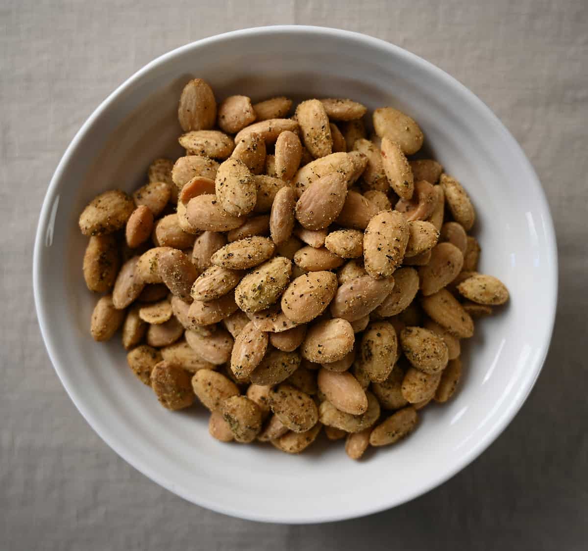 Top down image of a bowl of roasted garlic & herb almonds. 
