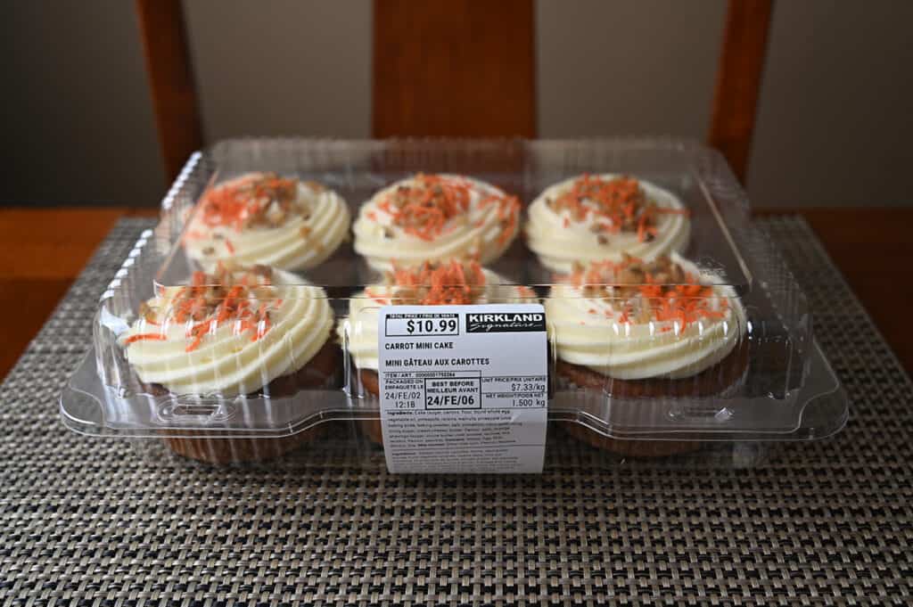 Image of the Costco Kirkland Signature Carrot Mini Cakes in the plastic packageing sitting on a table unopened.