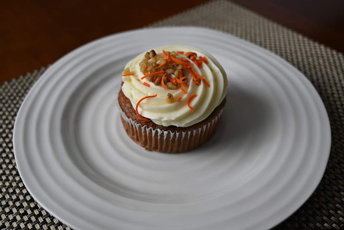 Sideview image of one carrot mini cake served on a white plate so you can see the size of the cake.