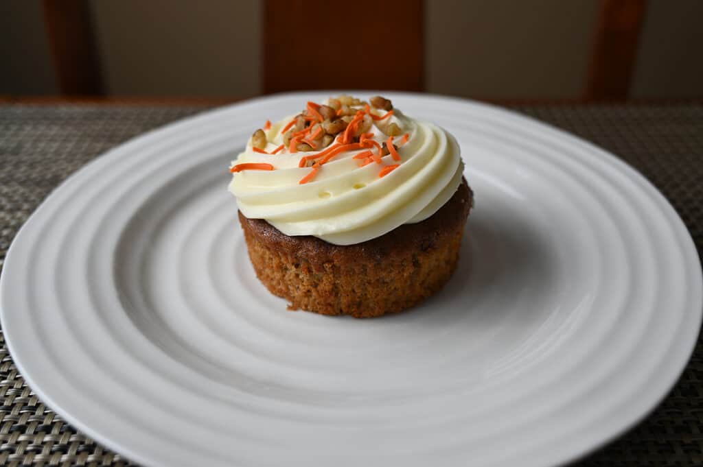 Side view image of one carrot mini cake unwrapped from the muffin liner.