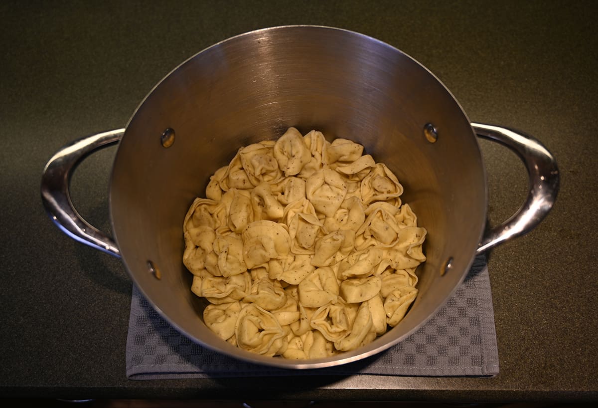 Top down image of a pot of tortelloni after being boiled.