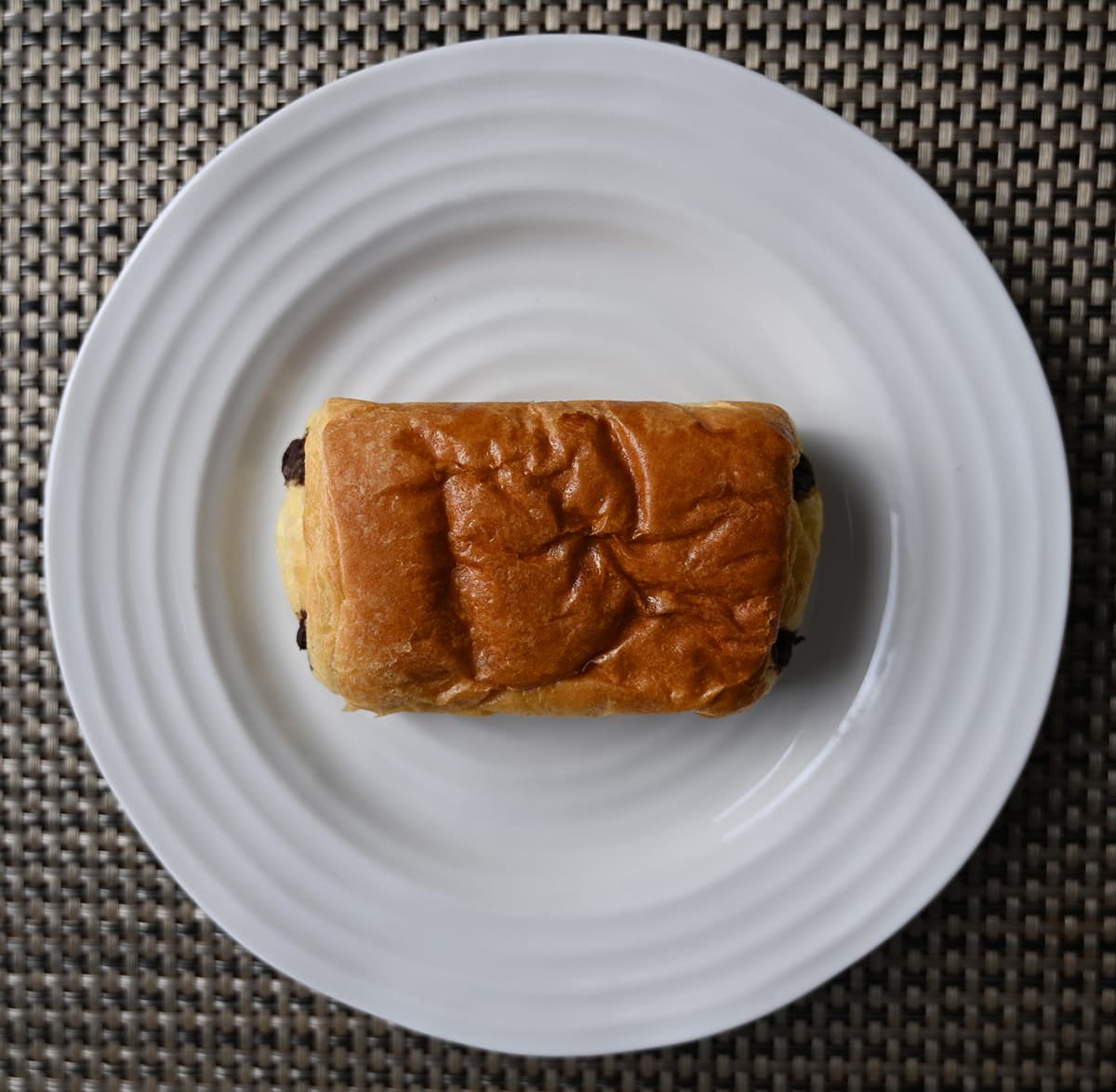 Top down image of one chocolate unpackaged and served on a white plate.