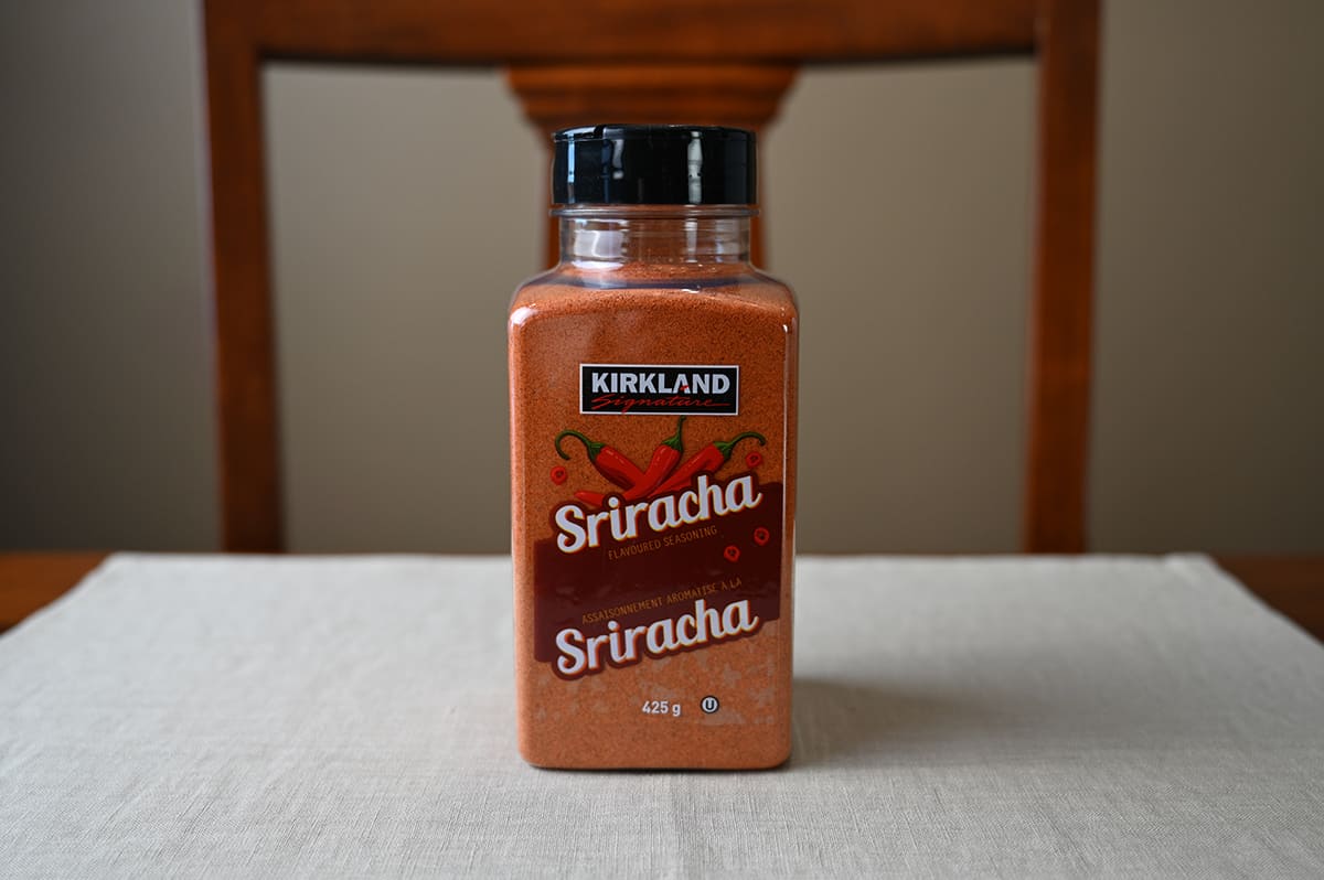 Image of the Costco Kirkland Signature Siracha Seasoning container unopened sitting on a table.