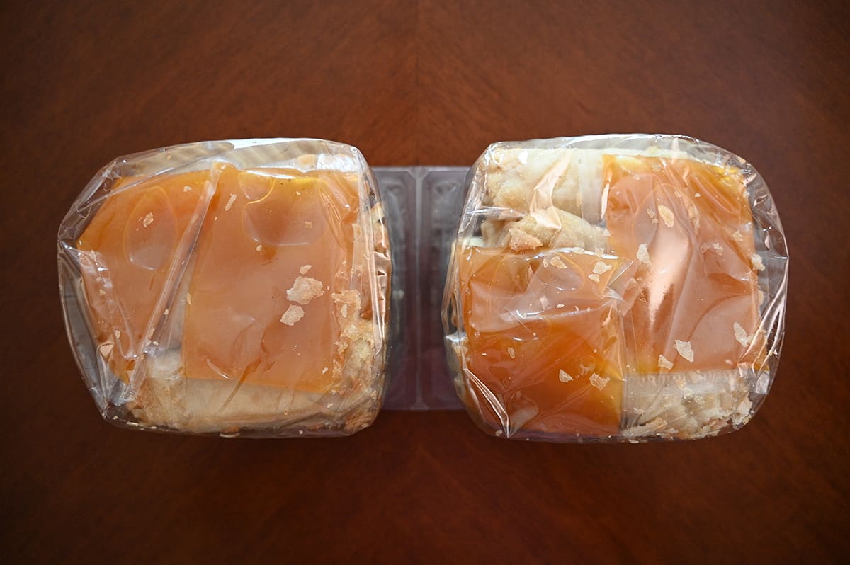 Top down image of the packages of spring rolls showing the sauce packets in the bottom of the packets.