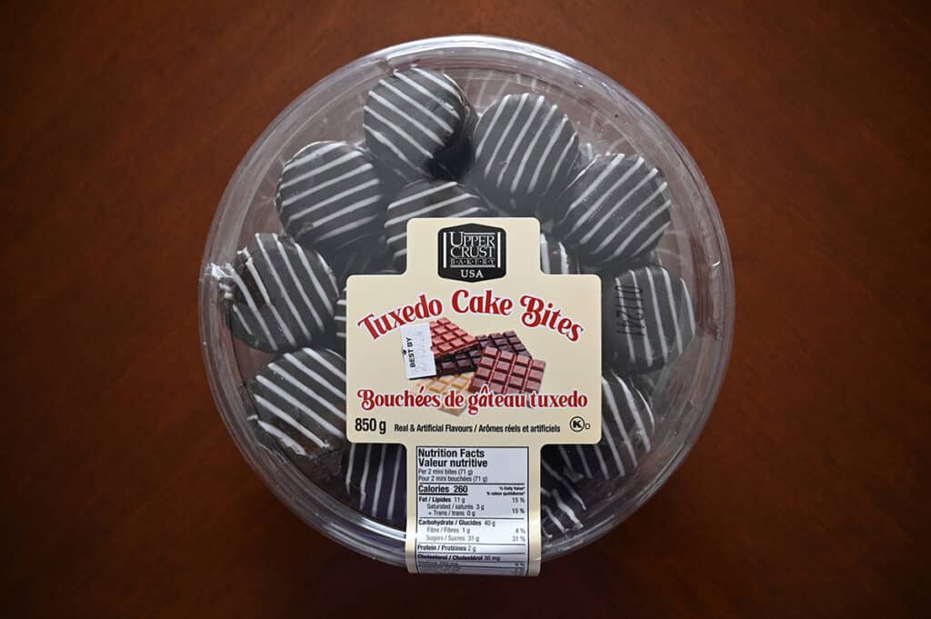 Top down image of the Upper Crust Bakery Tuxedo Cake Bites container unopened. 
